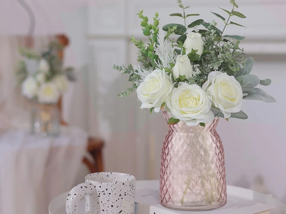 white flowers in a pink vase