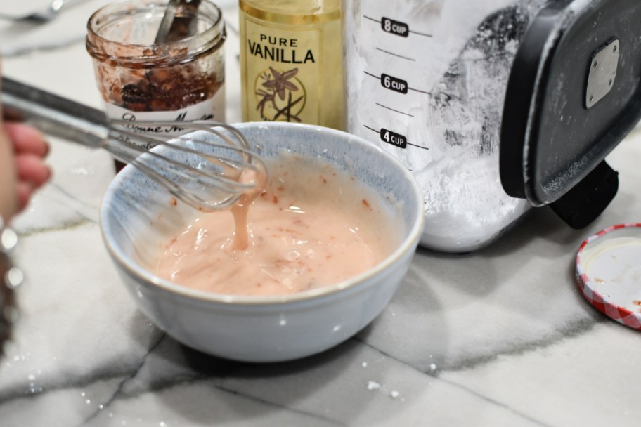 making strawberry glaze in a bowl