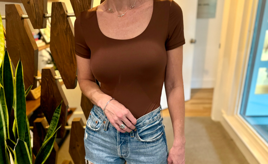 woman wearing brown bodysuit