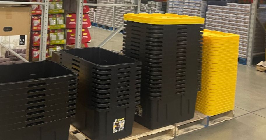black plastic 27 gallon totes stacked on an aisle in a sams club