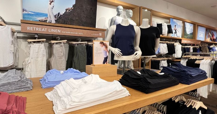 A table of folded Tank Tops at Athleta