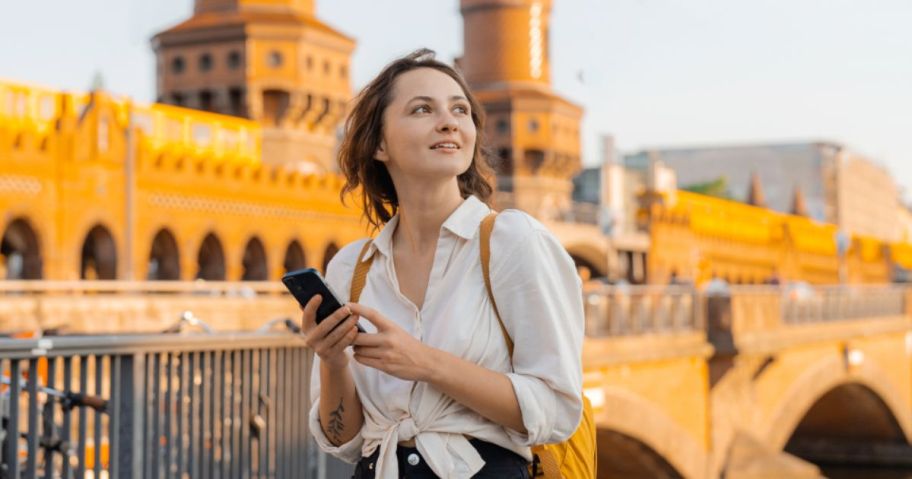 Woman looking at phone in a foreign country