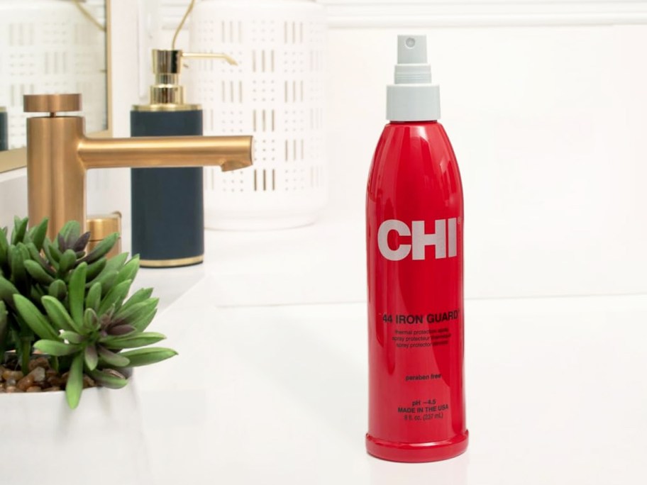 red bottle of CHI 44 Iron Guard Thermal Protection Spray on bathroom counter