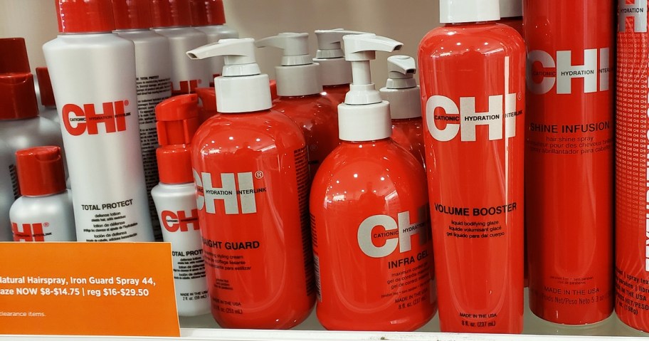 red bottles of chi hair styling products on store shelf