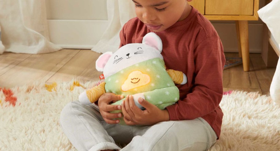 Child holding meditation toy sitting on the floor