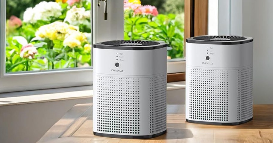 white white air purifiers sitting on floor near window