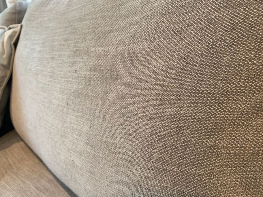 A couch cushion after using the fabric shaver.