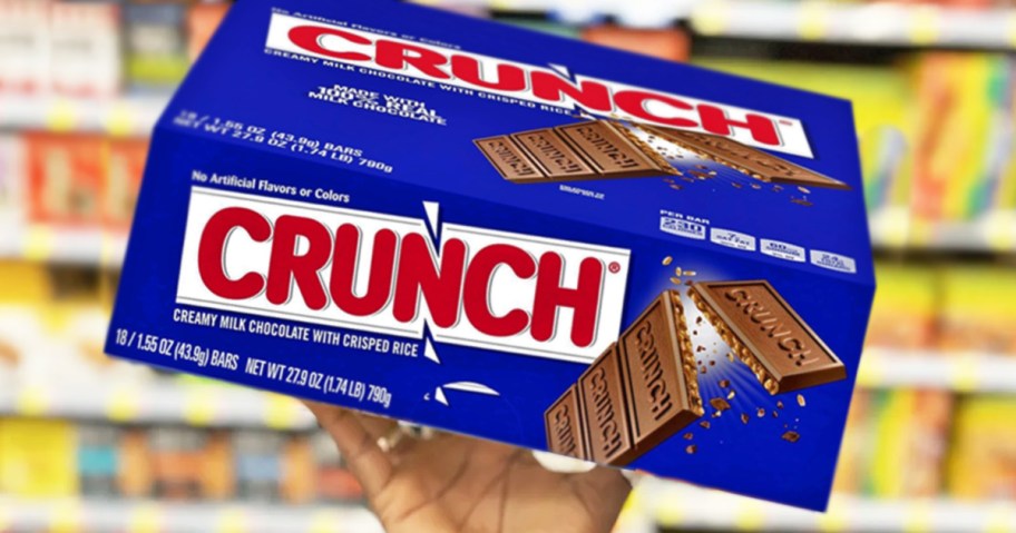 hand holding up a blue box of Crunch candy bars in store