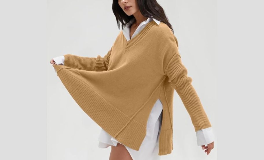 a model in a gold v neck sweater