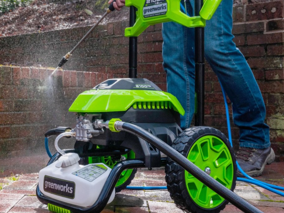 someone using a Greenworks Pressure Washer
