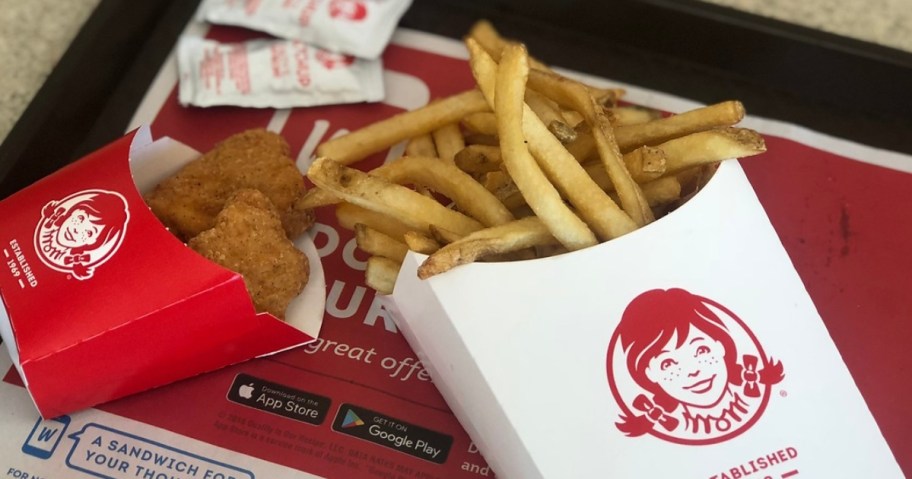 food tray with Wendy's french fires and chicken nuggets and ketchup packets