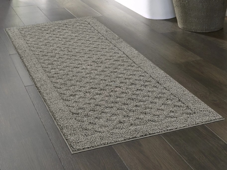 gray runner rug on dark wood floors