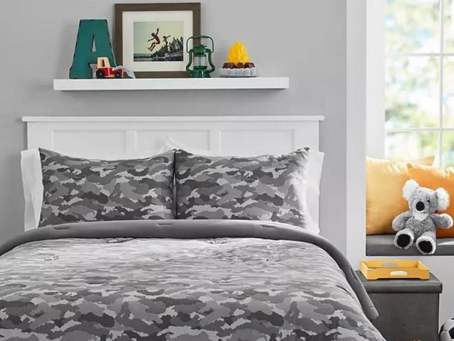 A member's mark camo print kids comforter set on a bed