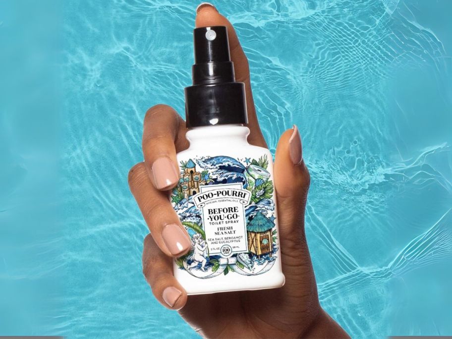 hand holding Poo-Pourri Before-You-GoToilet Spray in Fresh Sea Salt 2oz