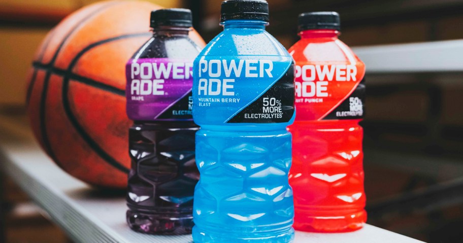 blue, purple, and red bottles of Powerade in front of basketball