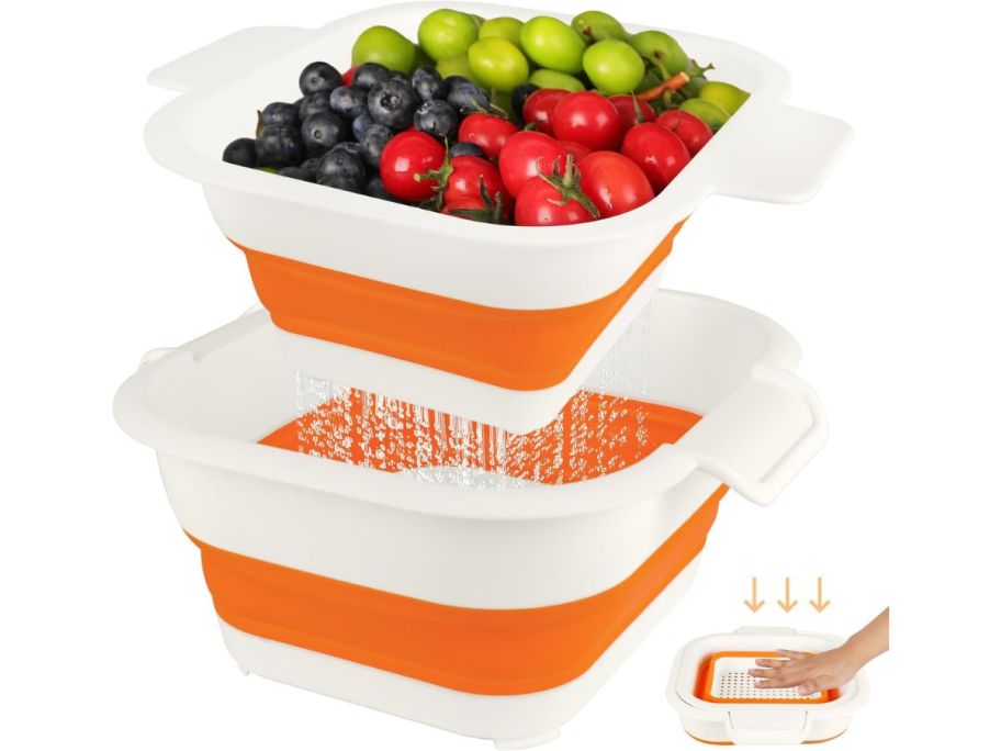 An orange collapsible strainer with fruit and veggies inside 