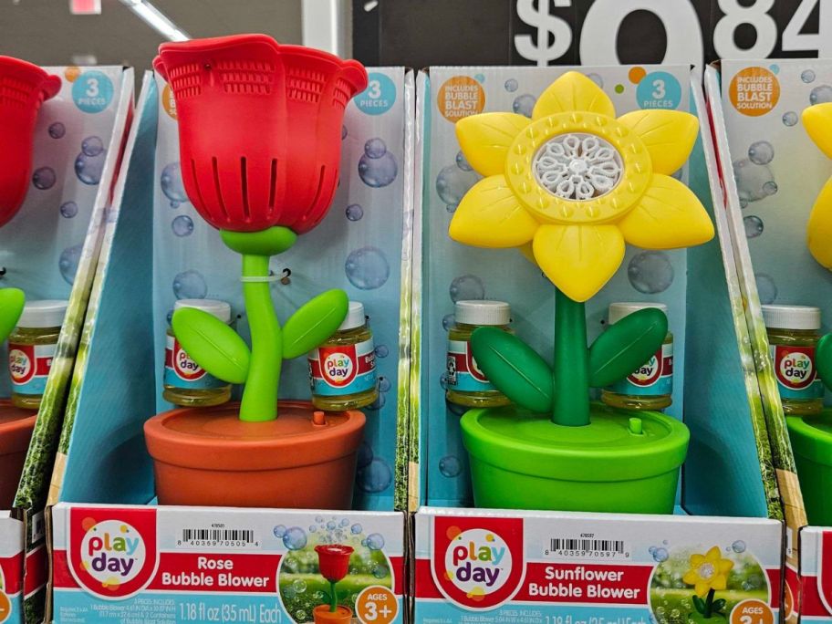 toy bubble maker machines shaped like flowers in flower pots on a shelf in store