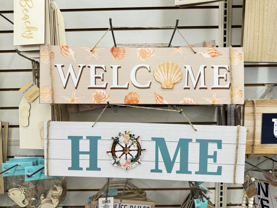 coastal wall decor signs hanging on wall at Dollar Tree