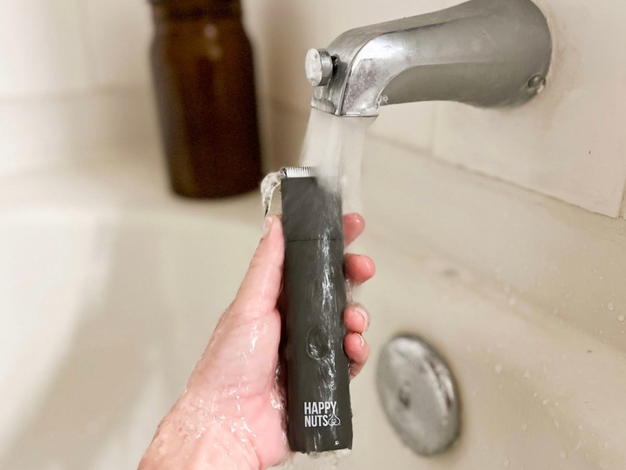 hand holding happy nuts trimmer under water