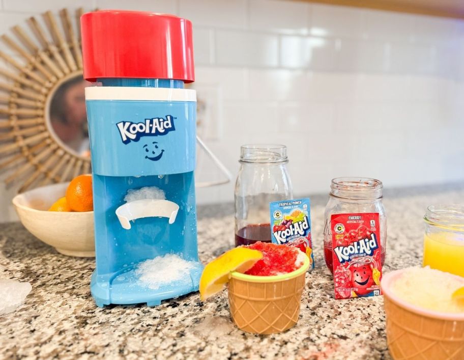 a kool-aid snow cone maker on a kitchen countertop shown with prepared snow cones