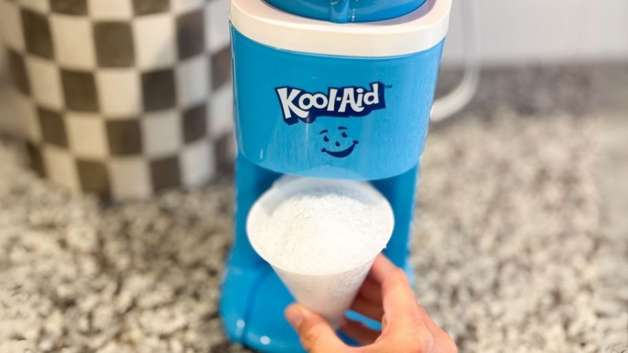 a kool-aid snow cone maker on a kitchen countertop shown with prepared snow cones