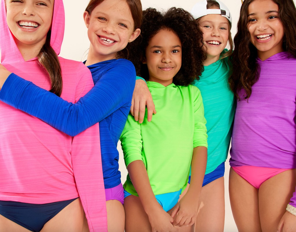 many kids in colorful rash guards