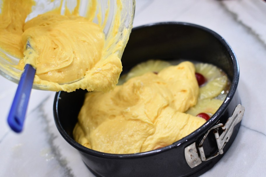 pouring cake mix into pan