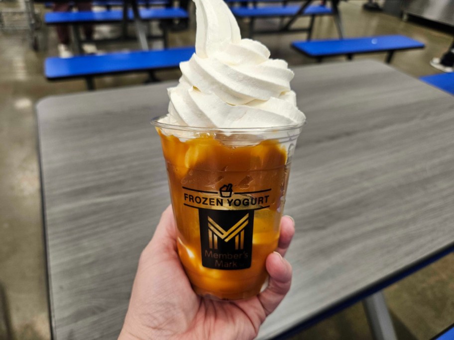 hand holding a tuxedo cake sundae inside of sams club