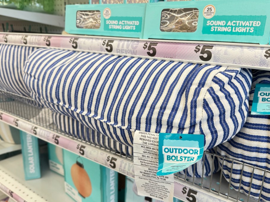 store display of bolster striped pillow with price tag around it