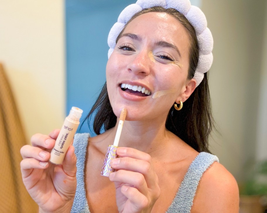 woman applying concealer to chin