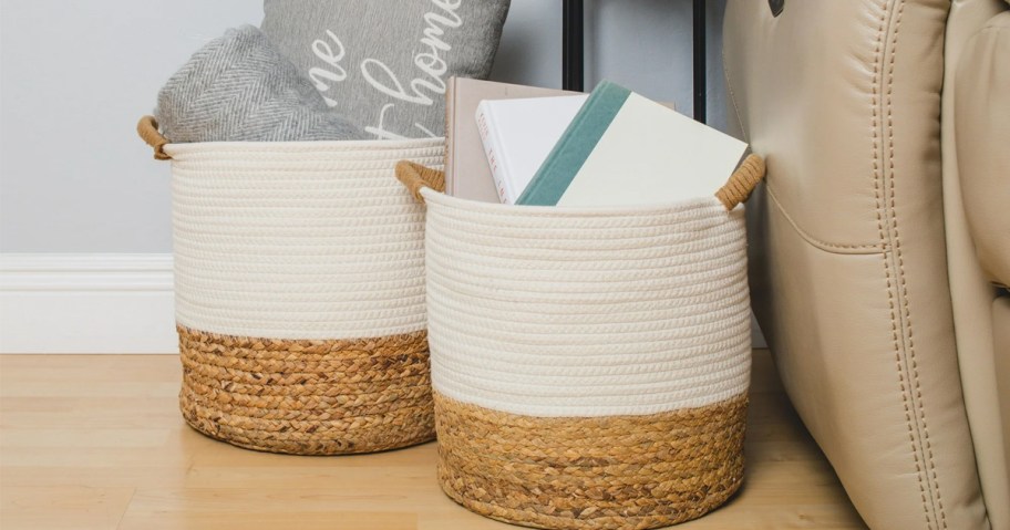 white and seagrass baskets with books and pillows inside on floor