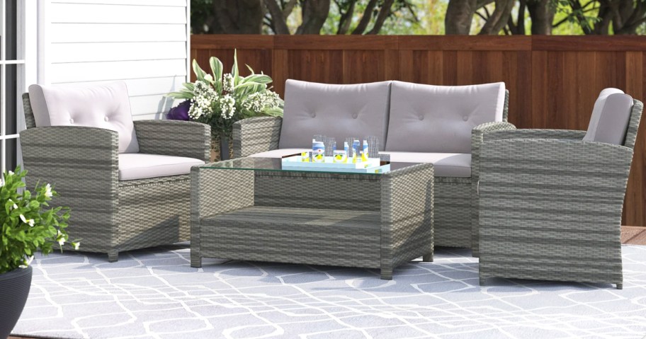 grey patio furniture set with grey cushions and matching coffee table