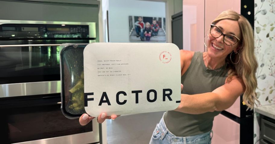 Collin Holding a Factor Meal in a kitchen