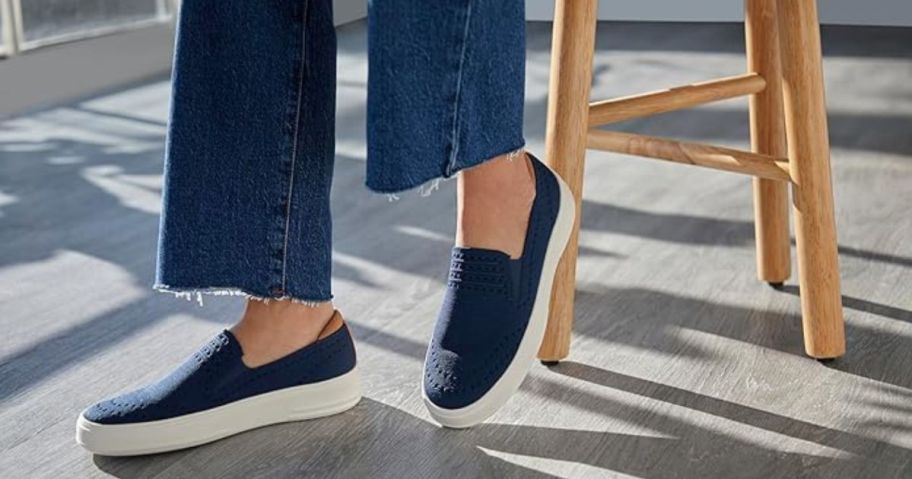 woman on a stool wearing Dearfoams Sophie Sneakers