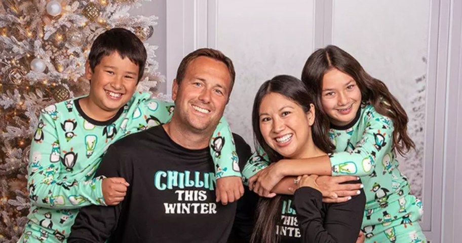 a picture of a family in matching holiday pajamas 