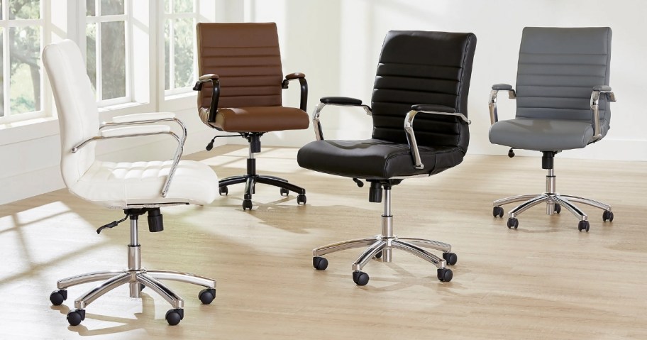 4 office chairs in different colors sitting in an office