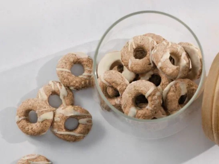 bowl of donut shaped dog treats with some on the side 