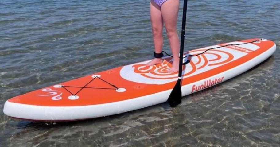 Girl Standing on an inflatable paddle board