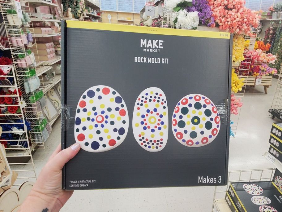 A hand holding a Make Market Rock Mold Kit