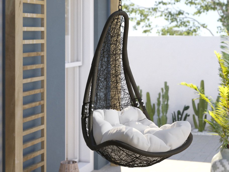 hanging patio chair with white cushions