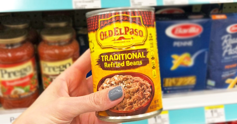 hand holding a can of Old El Paso Refried Beans in store