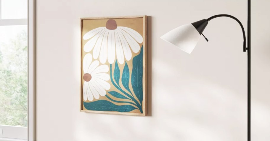 white daisy print framed on wall