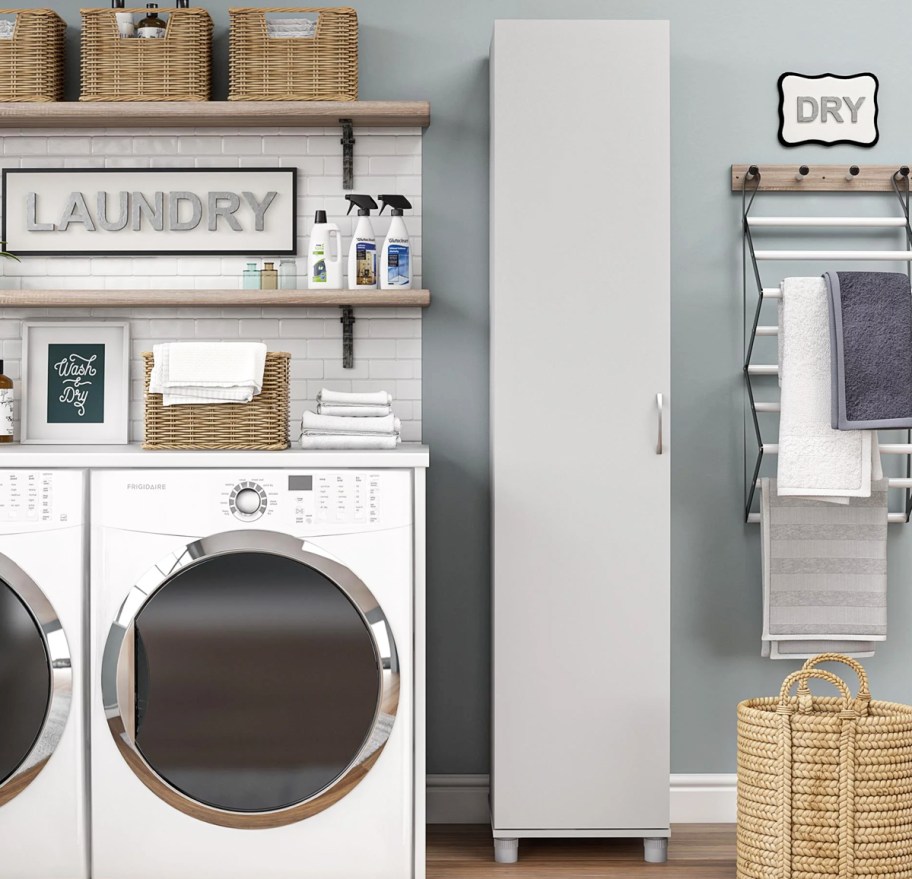 slim grey storage cabinet near washing machine and dryer