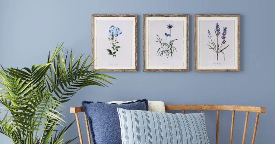 framed floral prints above wood bench