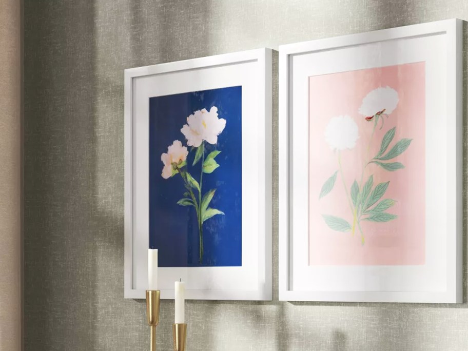 blue and pink framed floral posters on wall