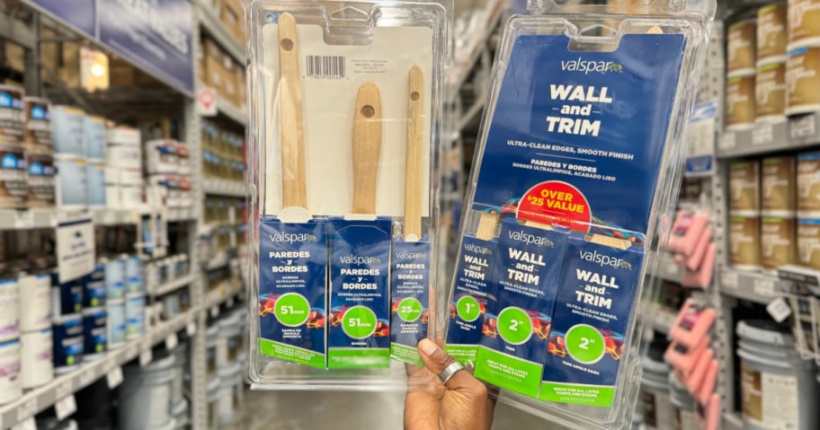 person holding Valspar Paint Brush 3 Pack inside lowe's store