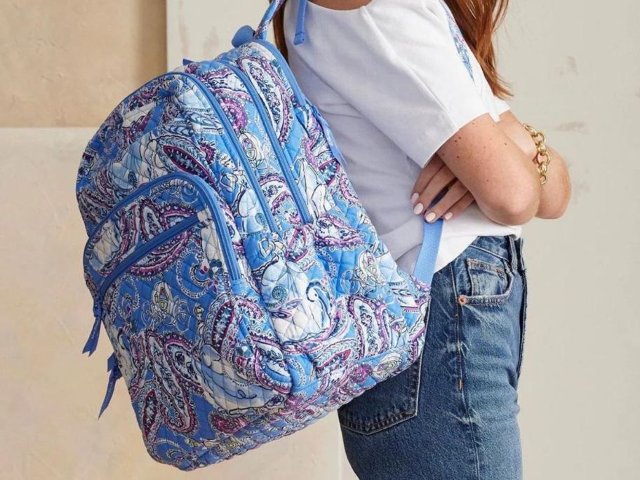 Woman wearing a Disney Vera Bradley Cinderella Campus Backpack