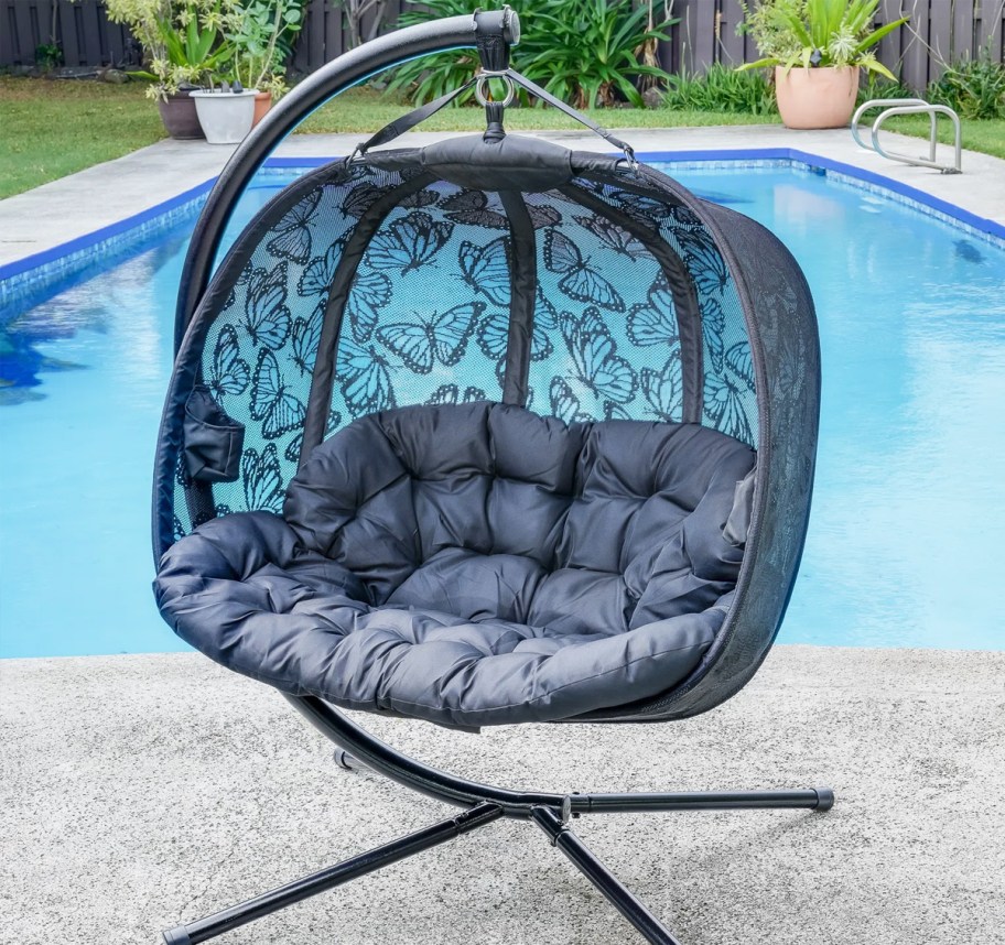 dark blue egg chair near pool