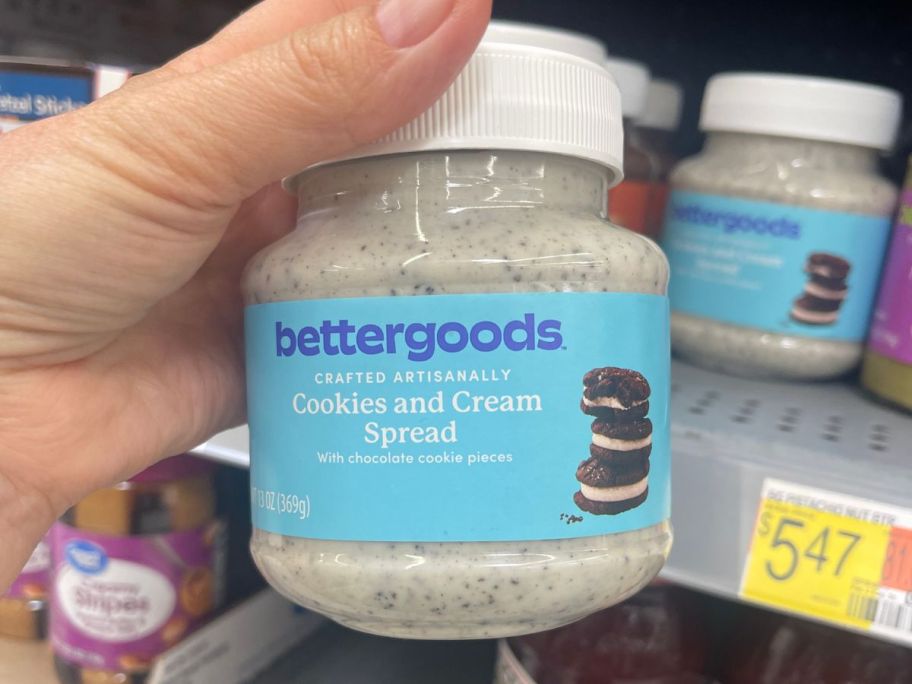 hand holding bettergoods Cookies & Cream Spread 13oz in store