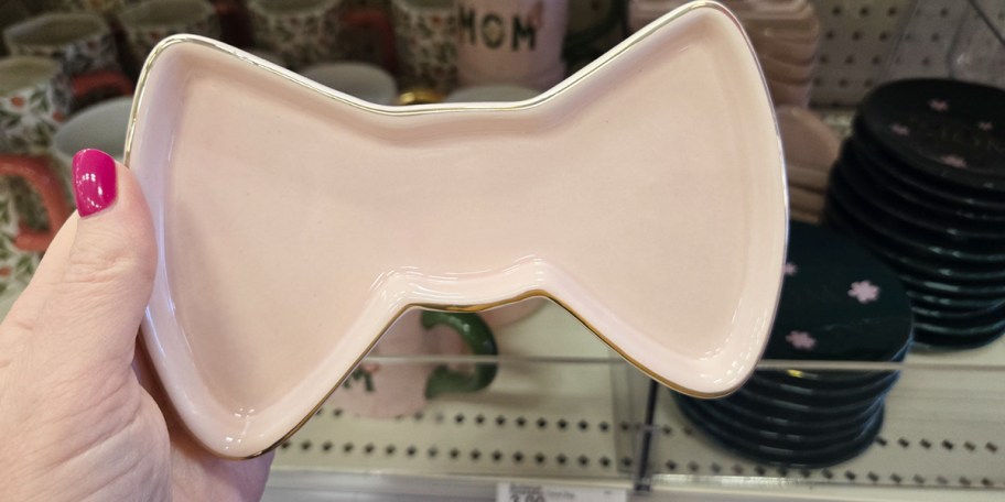 hand holding bow trinket tray 